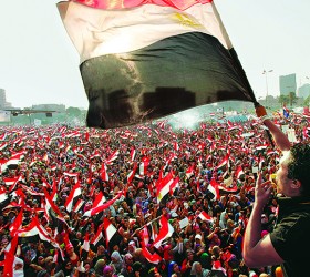 Protesters against Egyptian President Mohamed Mursi wave national flags in Tahrir Square in Cairo