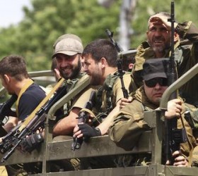 Pro-Russian separatists from the "East" battalion ride in a truck during a rally in the eastern city of Donetsk