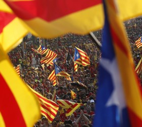 People hold "estelada" flags, Catalan separatist flags, during a gathering to mark the Calatalonia day "Diada" in central Barcelona