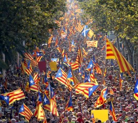 People hold "estelada" flags, Catalan separatist flags, during a gathering to mark the Calatalonia day "Diada" in central Barcelona