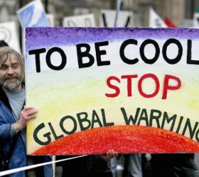 A protester holds a banner during a demonstration against climate change in central London