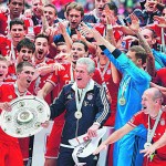 Bayern Munich's players present the German soccer championship trophy after their German first division Bundesliga soccer match against Augsburg in Munich