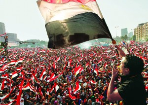 Protesters against Egyptian President Mohamed Mursi wave national flags in Tahrir Square in Cairo