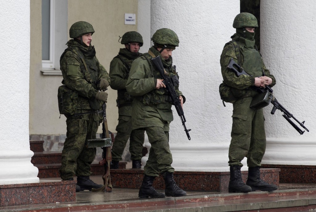 Armed men stand guard at the Simferopol airport in the Crimea region