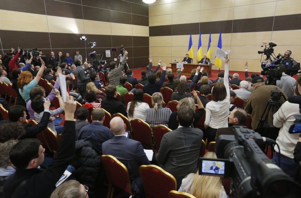 Journalists raise their hands to ask ousted Ukrainian President Yanukovich questions during  a news conference in the southern Russian city of Rostov-on-Don