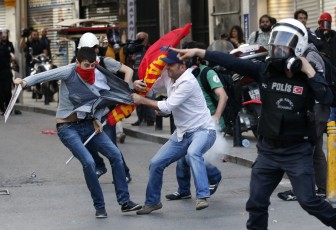 Police detain a protester during a demonstration to blame the government for the mining disaster, in Istanbul