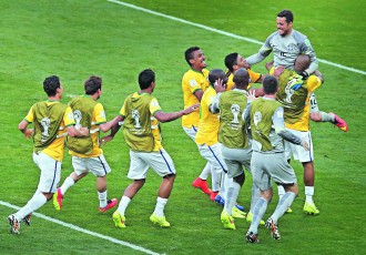 Brazil's goalkeeper Julio Cesar celebrates with teammates after the decisive penalty during the penalty shootout in their 2014 World Cup round of 16 soccer game against Chile at the Mineirao stadium in Belo Horizonte