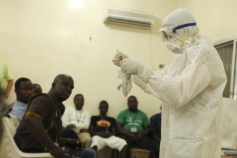 A Samaritan's Purse medical personnel demonstrates personal protective equipment to educate team members on the Ebola virus in Liberia in this undated handout photo
