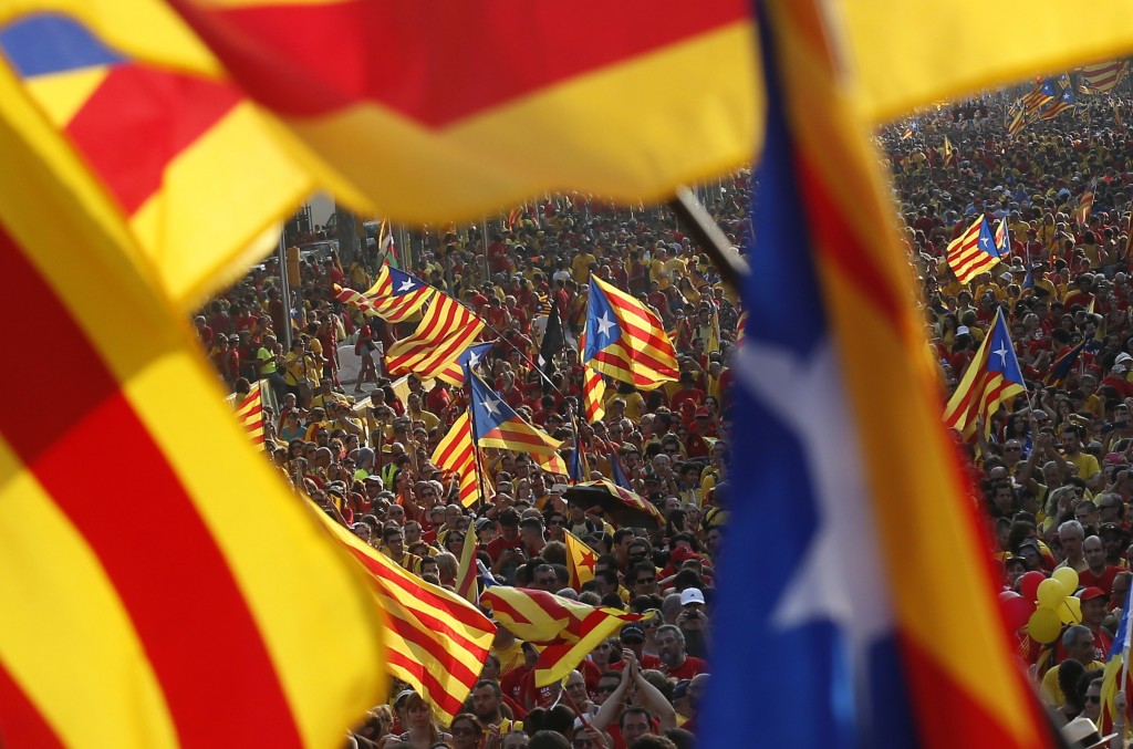 People hold "estelada" flags, Catalan separatist flags, during a gathering to mark the Calatalonia day "Diada" in central Barcelona