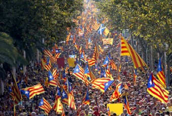 People hold "estelada" flags, Catalan separatist flags, during a gathering to mark the Calatalonia day "Diada" in central Barcelona